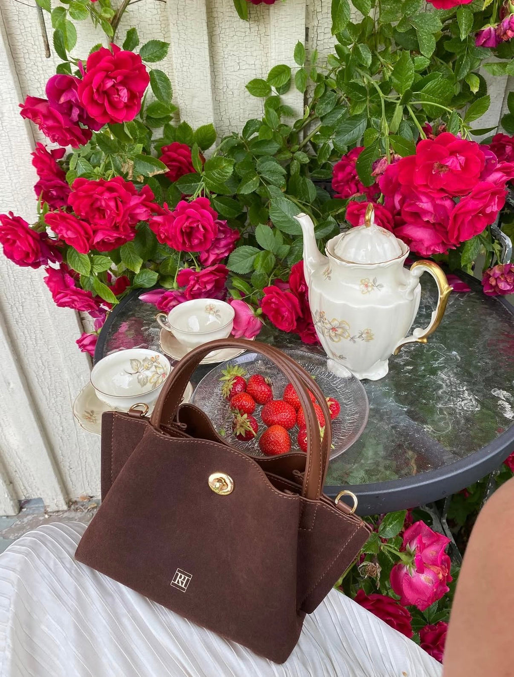 A mini bag in a garden with beautiful flowers